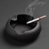 black modern ashtray with cigarette