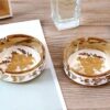 Ceramic Ashtray Golden And White On Table