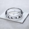 Round Crystal Glass Ashtray transparent on book