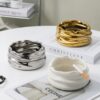 Three Stylish Ashtrays In Silver Gold And White