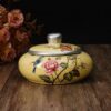 yellow ceramic ashtray with lid with flower paintings